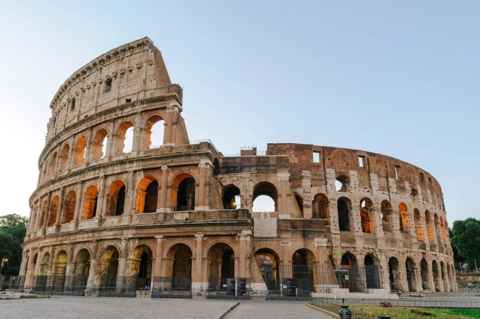 The Colosseum in Rome under a clear sky during the golden hour